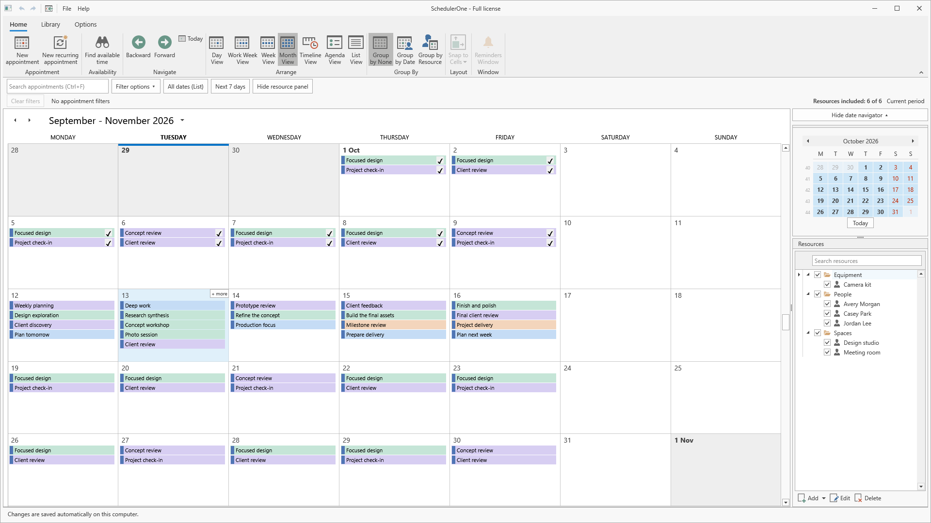 SchedulerOne Month view showing color-coded appointments and completion markers across the calendar.